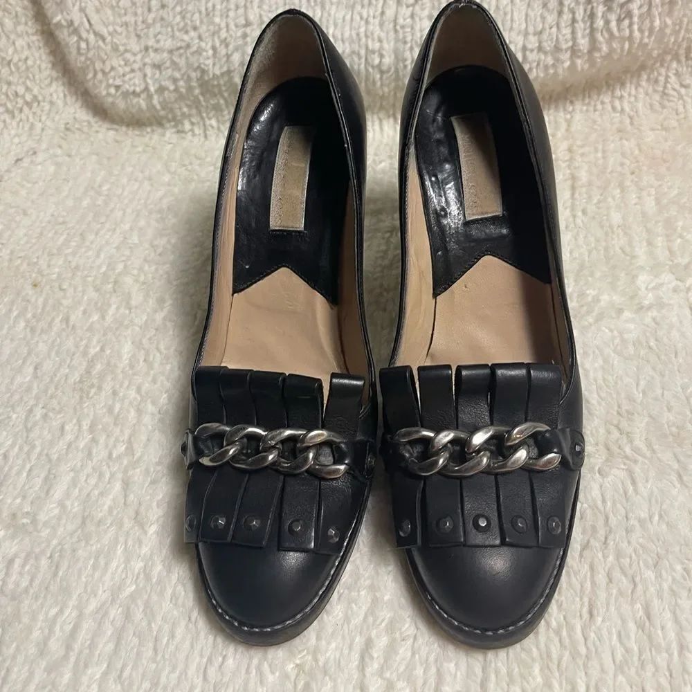 Michael Kors leather Black slip onโheels with chain and studs accents SZ7.5M